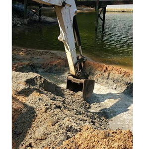 Excavation of sediment that deposited into a lake cove.